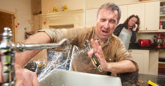 water spraying man working on sink